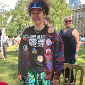A smiling participant at Duckie's summer fayre showing off their badges