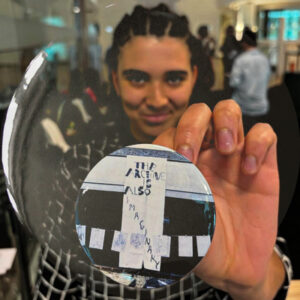 A participant showing off a badge saying The Archive is Also Imaginary