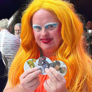 Davina Starr of Drag Syndrome showing off her badges