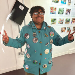 Alex showing off his jacket covered in dozens of badges