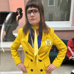 Artist Sadie Lee wearing a badge saying Dykes for Trans Rights