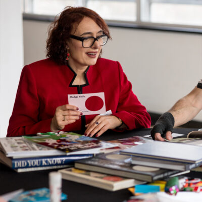 A participant at the badge table looking intrigued at the process