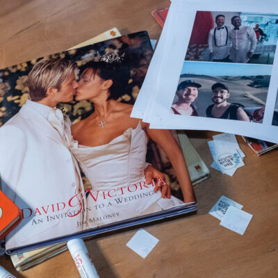 Wedding-themed pictures and books at a badge station for a wedding