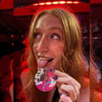 Diva Dungeon promoter Taman licking a pink badge