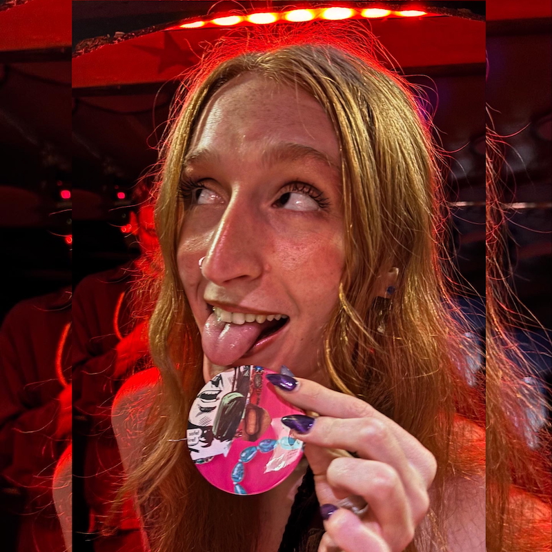 Diva Dungeon promoter Taman licking a pink badge