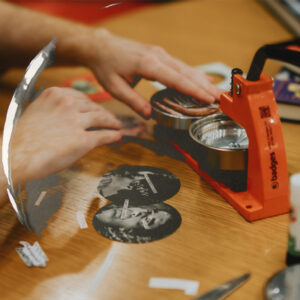 Close-up of Dev operating the badge machine