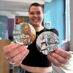 Smiling participant showing off their badges